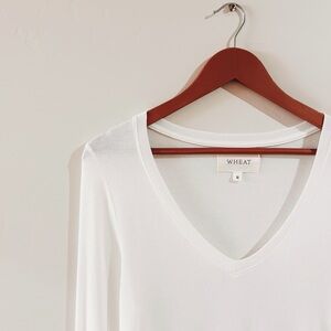 belle shops | masion wheat memphis long sleeve v neck tee in white ↷